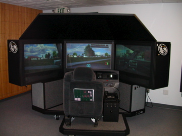 Several PatrolSim units in a training room with a desktop computer in the foreground, documenting a multi-simulator setting in the archive