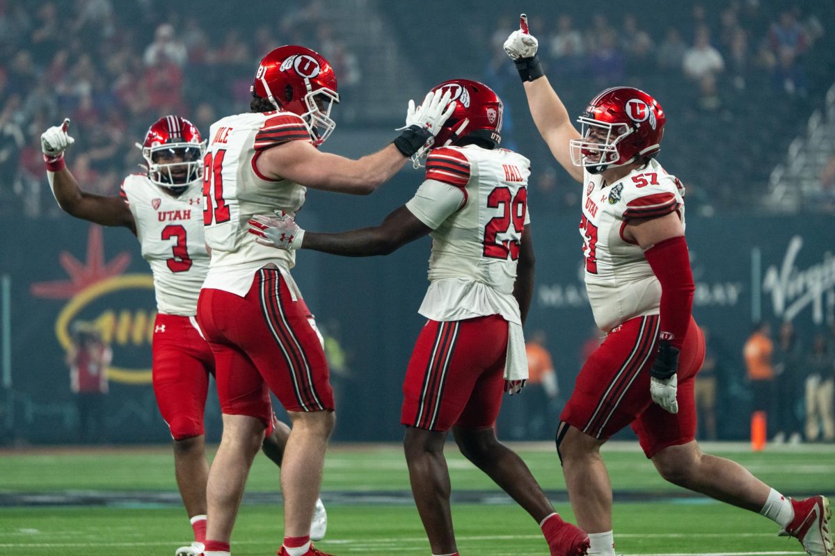 Utah Utes football players celebrating a play on the field